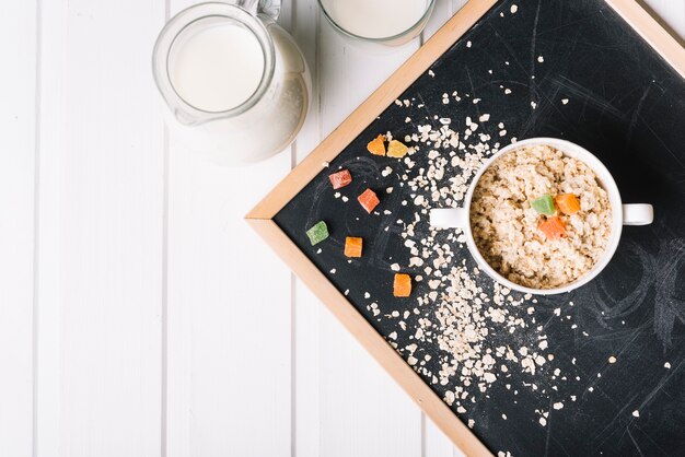 Oatmeal with jelly candies topping on slate tray on table