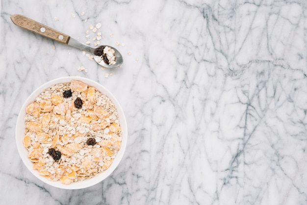 Oatmeal with raisins in big bowl on table