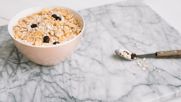 Oatmeal with raisins in bowl on table