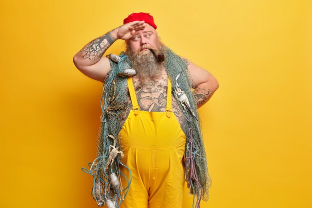 Obese bearded male sailor wiith fishing net