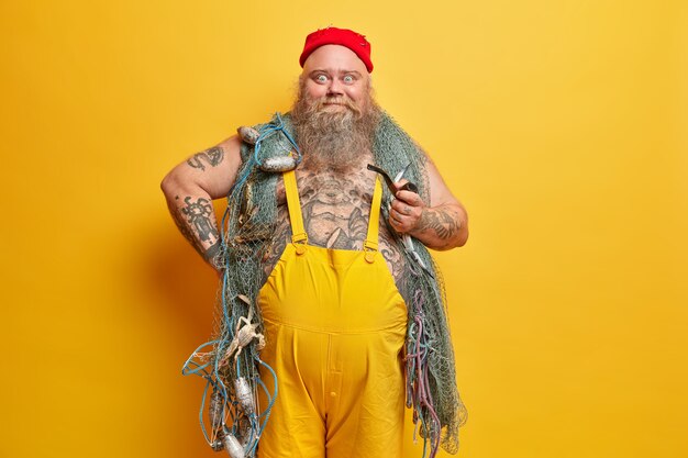 Obese bearded male sailor wiith fishing net