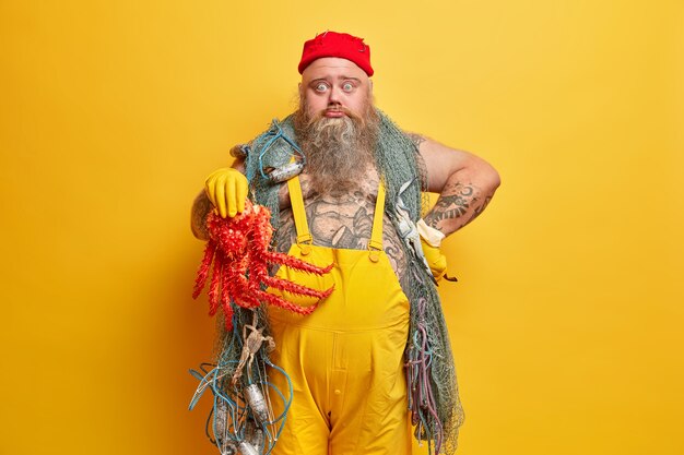 Obese bearded male sailor wiith fishing net