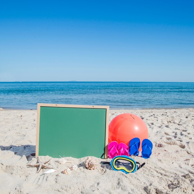 Objects in composition on sandy beach