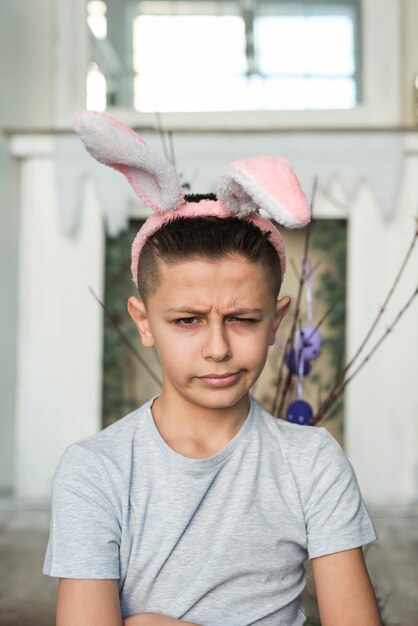Offended boy in bunny ears 