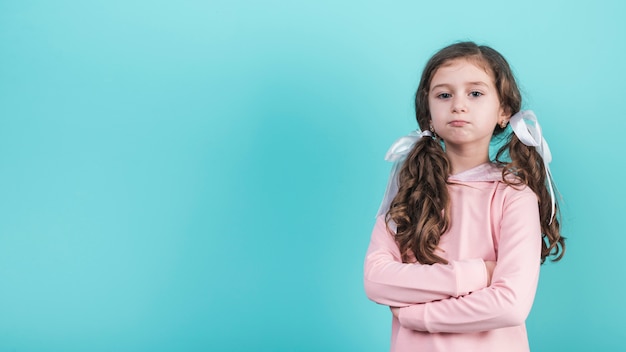 Offended girl standing with crossed arms