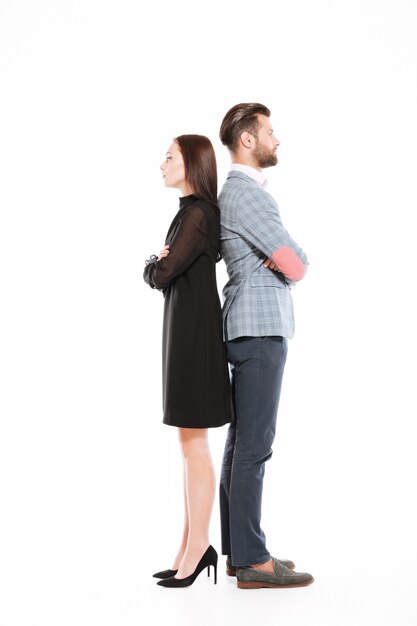 Offended serious loving couple standing isolated