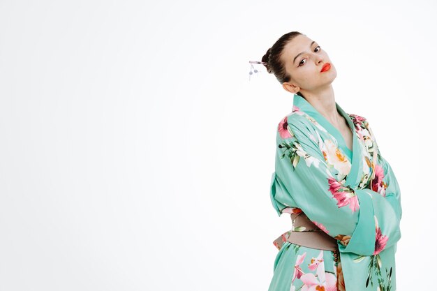 Offended Woman in traditional japanese kimono being angry at someone with arms crossed on her chest on white