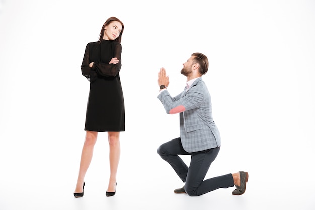 Offended young loving couple standing isolated