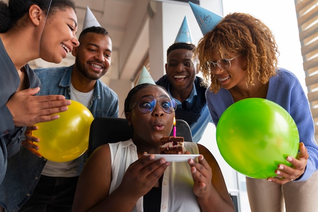 office coworkers celebrating an event with balloons
