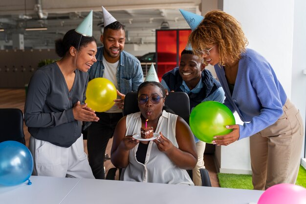 Office coworkers celebrating an event with balloons