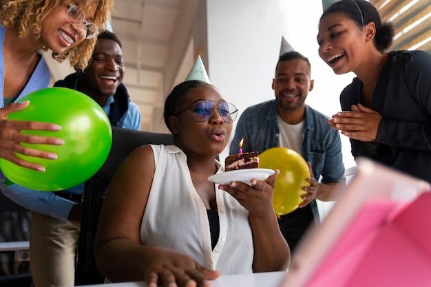 Office coworkers celebrating an event with balloons