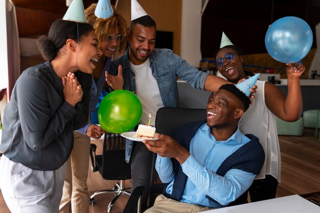 Office coworkers celebrating an event with balloons