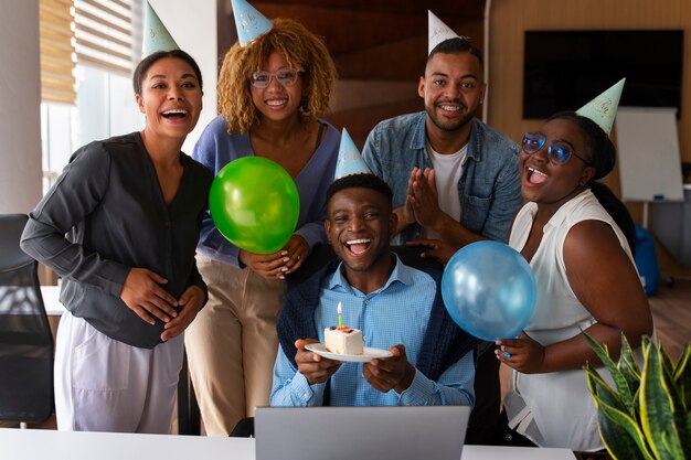 Office coworkers celebrating an event with balloons