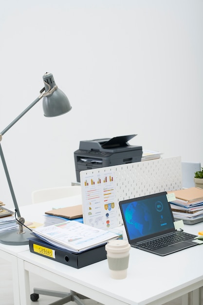 Free photo office desk arrangement with laptop