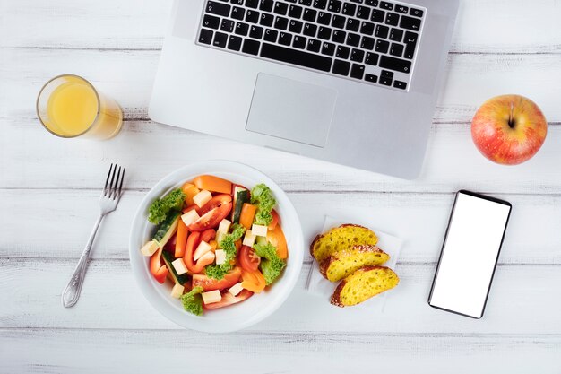 Office desk and laptop with healthy food