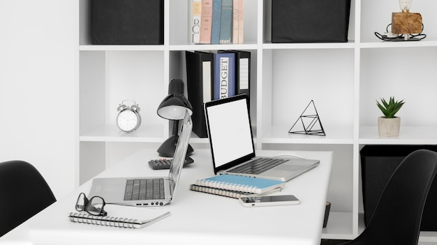 Office desk surface with two laptops