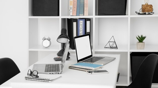 Office desk surface with two laptops