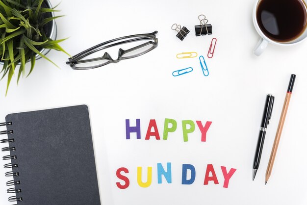 Office desk table with happy sunday word