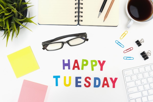 Free photo office desk table with happy tuesday word