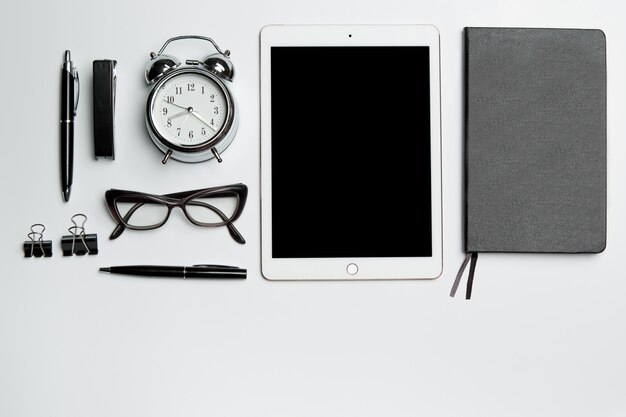 Office desk table with laptop, supplies, phone and coffee cup