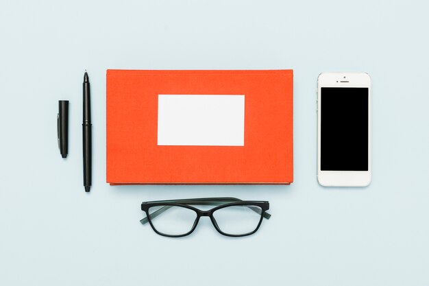 Office desk with book, glasses and pen