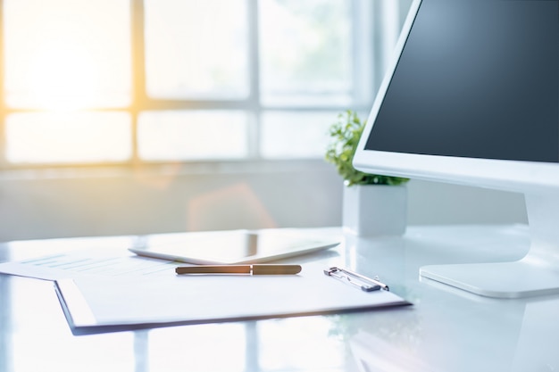 Office desk with computer and clipboard