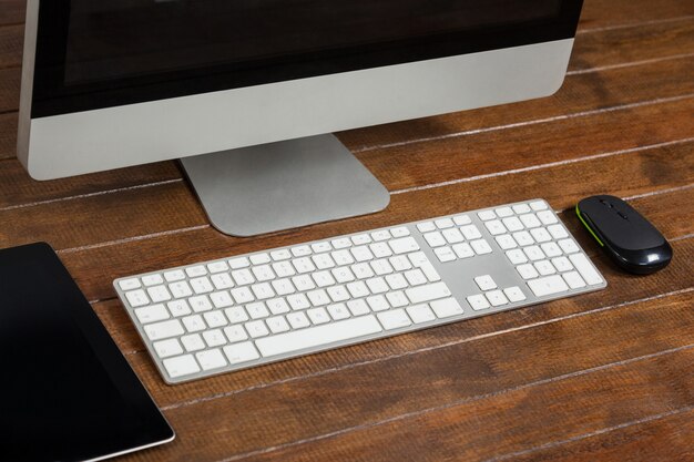 Office desk with computer and digital tablet