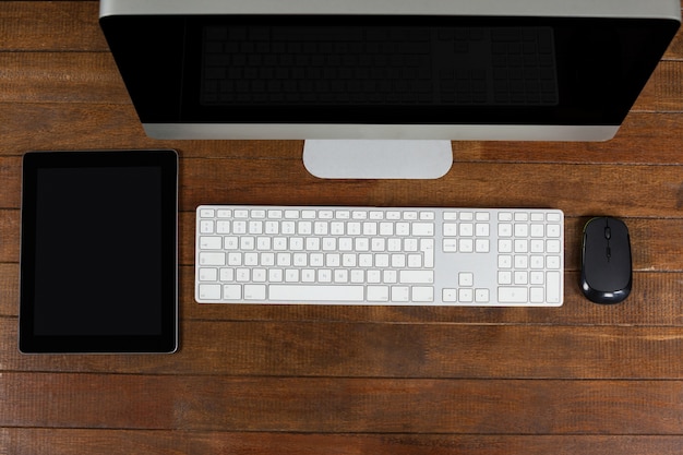 Office desk with computer and digital tablet