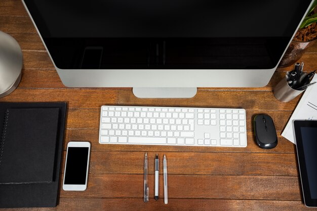 Office desk with computer and mobile phone