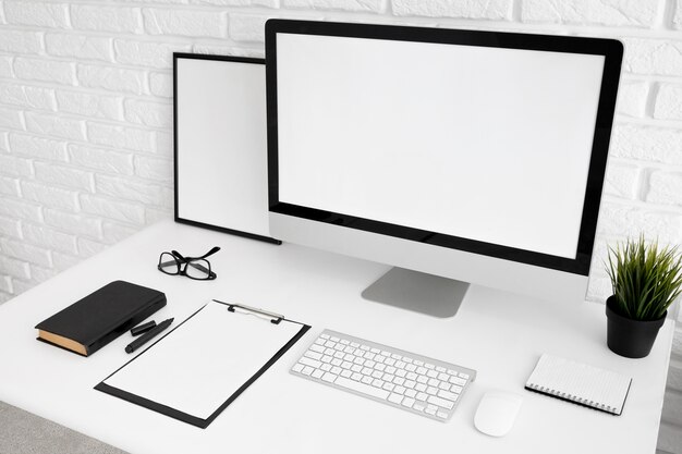 Office desk with computer screen and clipboard