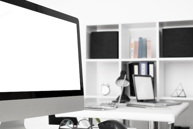 Office desk with computer screen and shelf