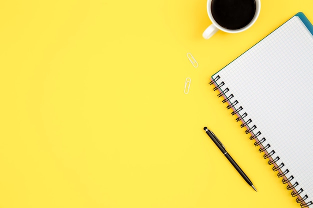 Office desk workspace on bright color yellow background