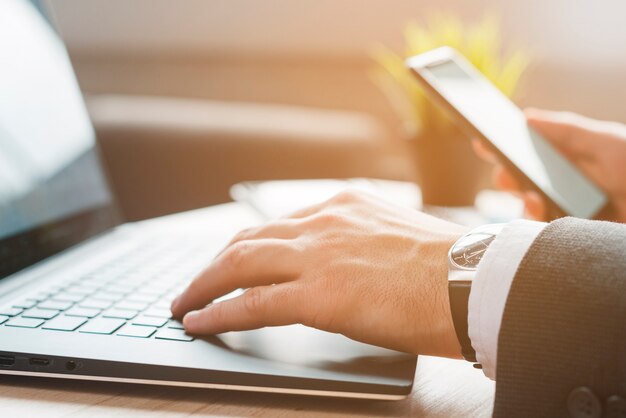 Office desktop with laptop and a business man