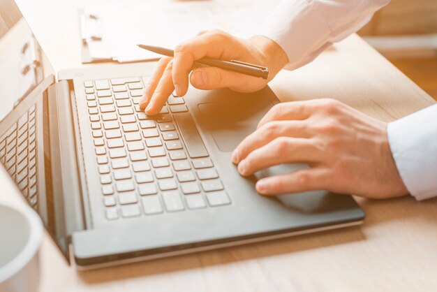 Office desktop with laptop and a business man