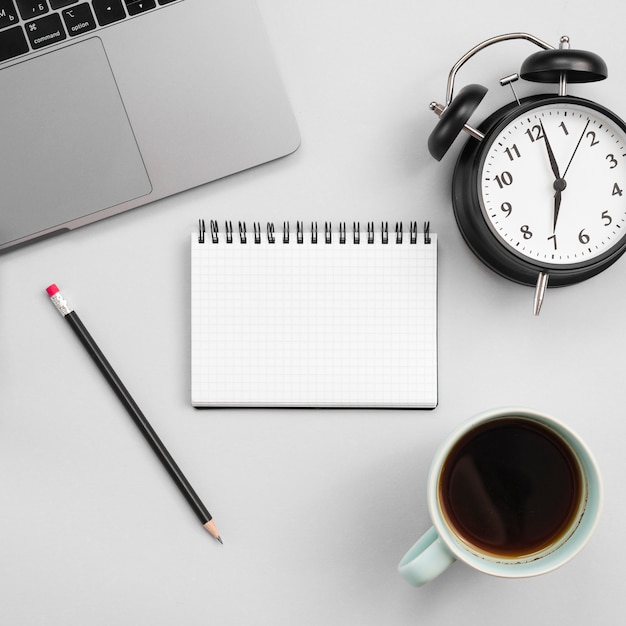 Office desktop with laptop and a clock