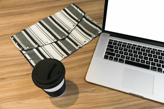 Office desktop with laptop and a coffee cup