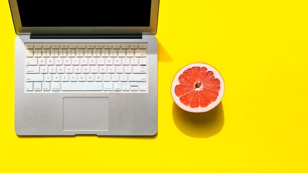 Office desktop with a laptop and fruit