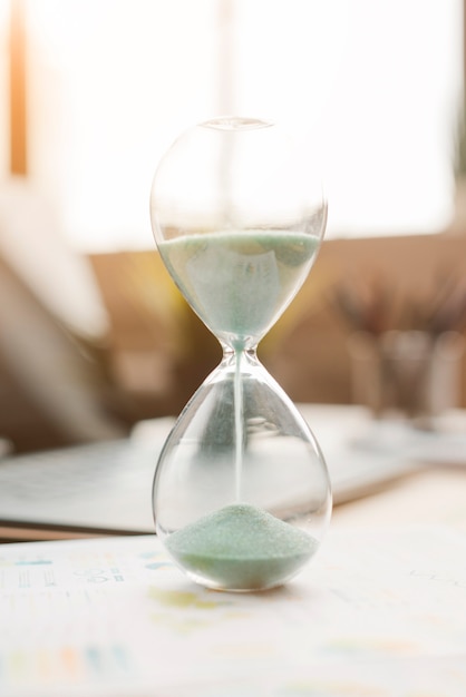 Free photo office desktop with a sand clock