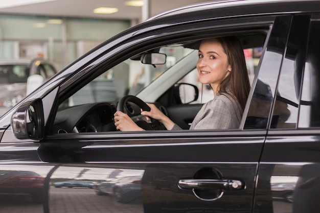 Office dressed woman sitting in a car