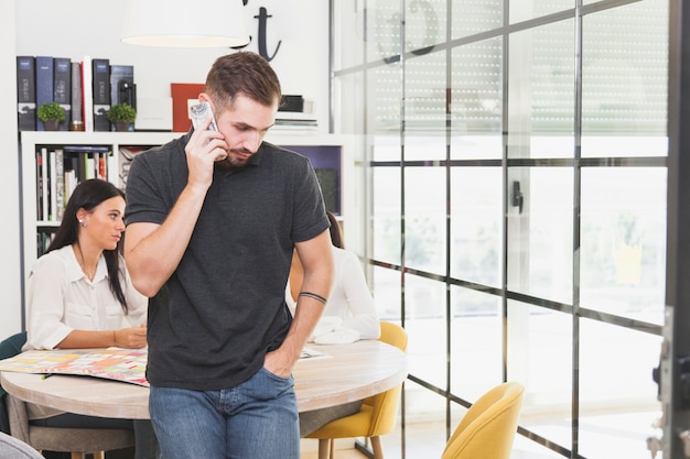 Office employee talking on smartphone