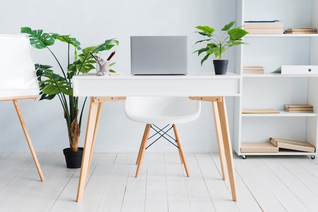 Office employee workspace with laptop on table