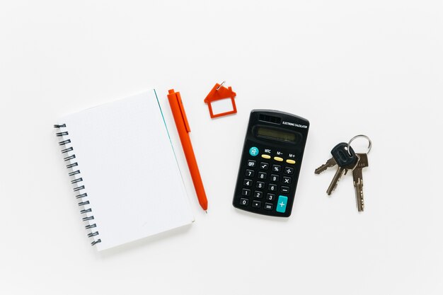 Office stationery and keys isolated on white backdrop