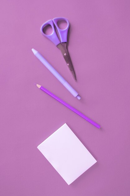 Office stationery on purple surface