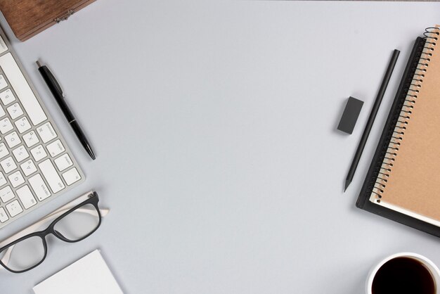 Office supplies with keyboard on gray desk