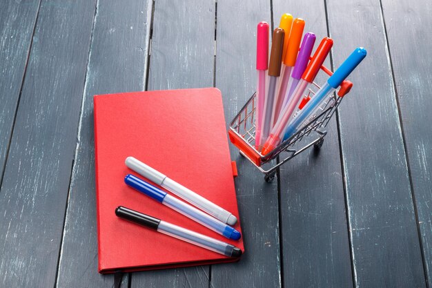 Office table with notebook and markers