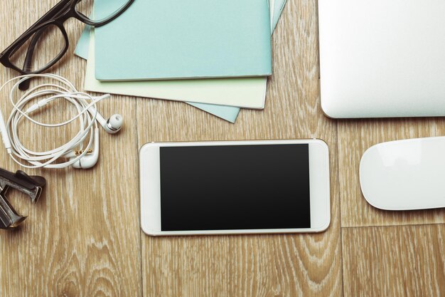 Office table with smartphone on it view from above