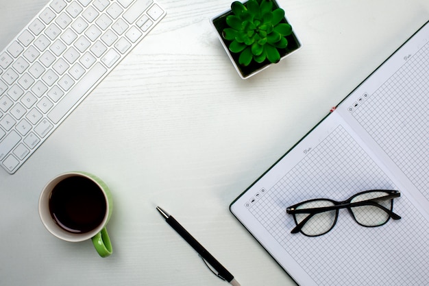 Office tools and a cup of coffee on the table