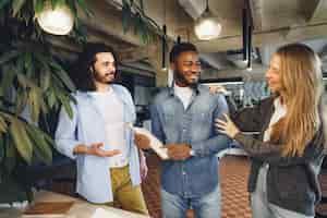 Free photo office work team greeting their new african american male employee