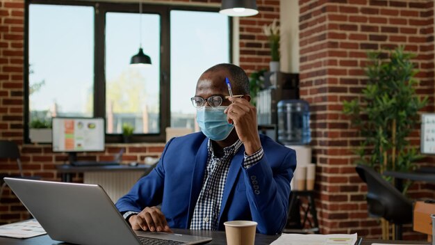 Office worker feeling pensive and thinking about business strategy to work on financial presentation. Thoughtful male employee brainstorming ideas to create statistics research on website.