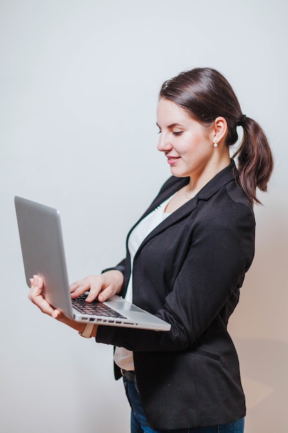 Office worker standing and using laptop